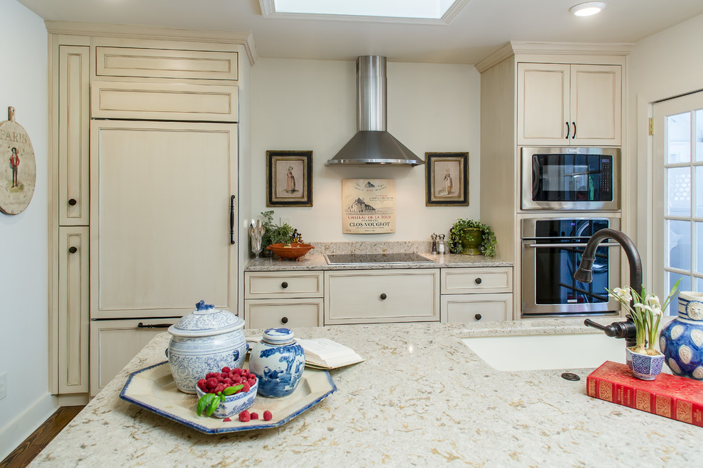 Design ideas for a mid-sized traditional galley eat-in kitchen in Atlanta with distressed cabinets, quartz benchtops, stainless steel appliances, recessed-panel cabinets, an undermount sink, dark hardwood floors and with island.