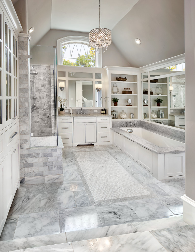Photo of a large traditional master bathroom in Dallas with recessed-panel cabinets, white cabinets, an undermount tub, an alcove shower, marble floors and marble benchtops.