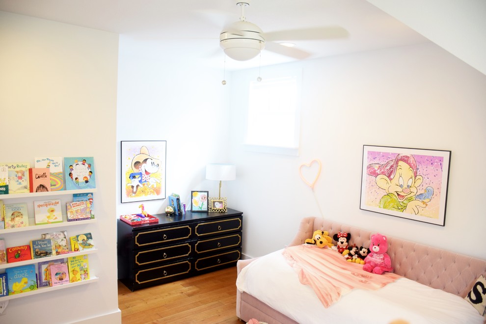 Large eclectic kids' room in Dallas with white walls, light hardwood floors and brown floor for girls.