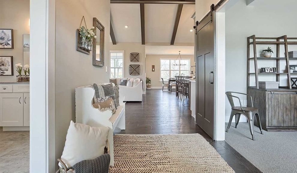 Mid-sized country foyer in Other with grey walls, dark hardwood floors and a single front door.