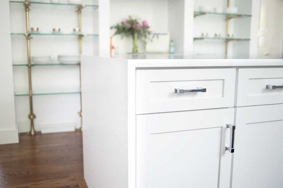 Enclosed kitchen - transitional dark wood floor and brown floor enclosed kitchen idea with an undermount sink, shaker cabinets, white cabinets, quartz countertops, white backsplash, stone slab backsplash, stainless steel appliances and an island
