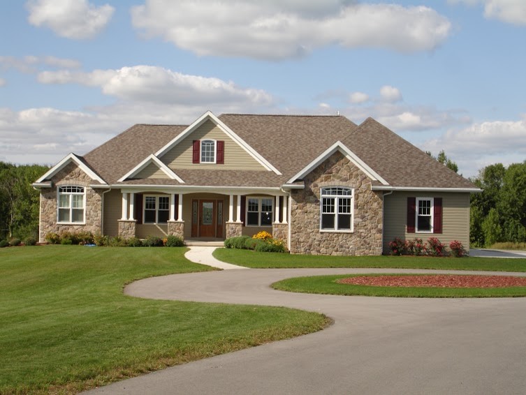 Large beige two-story wood exterior home photo