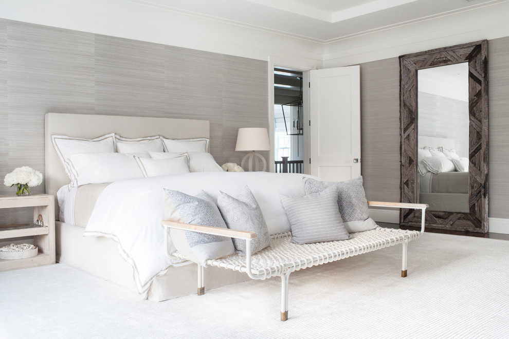 Inspiration for an expansive transitional master bedroom in New York with beige walls, dark hardwood floors, a standard fireplace and a stone fireplace surround.