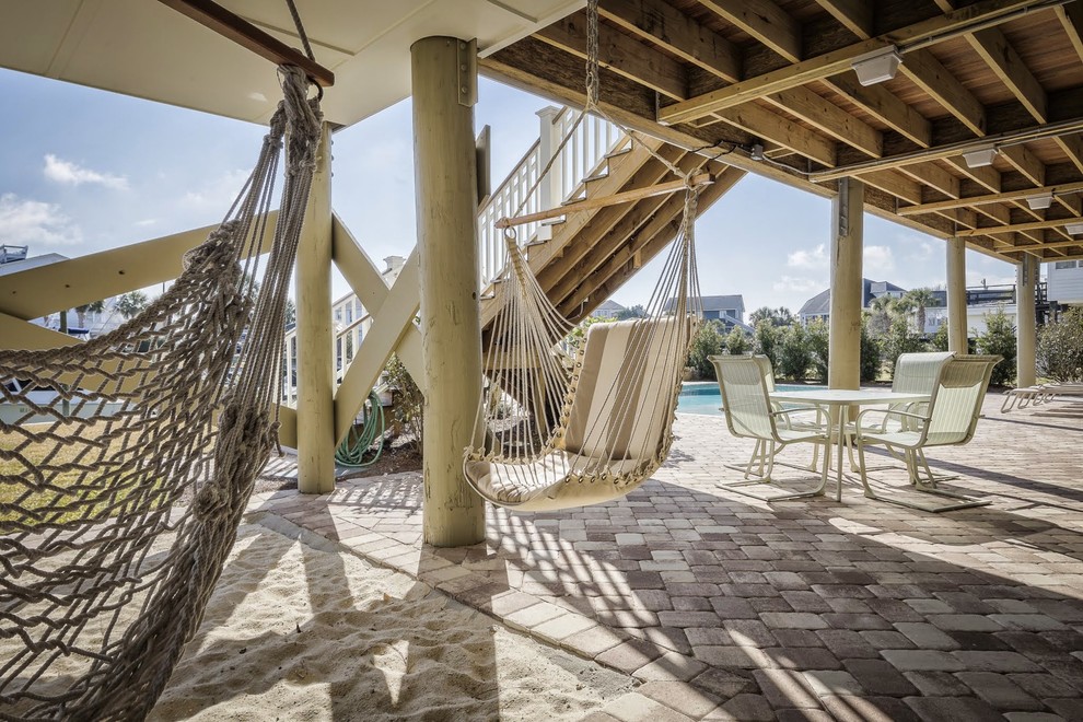 Example of a large beach style backyard brick patio design in Charleston