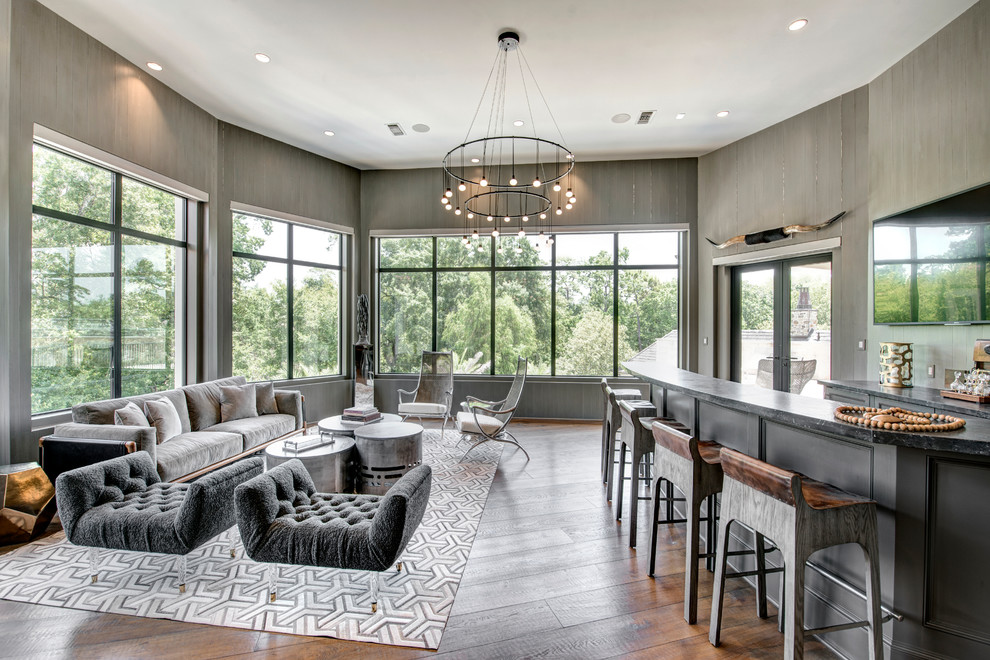 Design ideas for a transitional u-shaped seated home bar in Houston with recessed-panel cabinets, grey cabinets, grey splashback, medium hardwood floors, brown floor and grey benchtop.