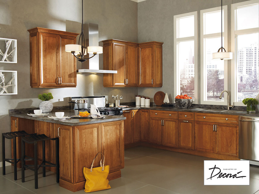 Small l-shaped eat-in kitchen photo with medium tone wood cabinets, stainless steel appliances, a peninsula and gray countertops