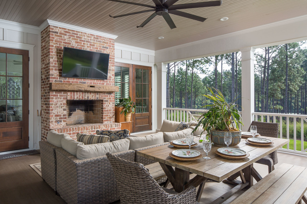Photo of a large country backyard verandah in Atlanta with with fireplace, decking and a roof extension.