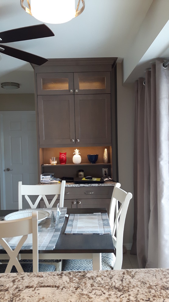 Inspiration for a mid-sized transitional u-shaped porcelain tile eat-in kitchen remodel in Toronto with an undermount sink, shaker cabinets, gray cabinets, granite countertops, gray backsplash, stainless steel appliances and a peninsula
