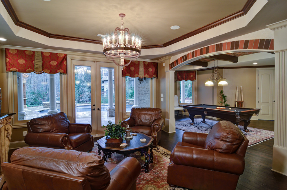 Large traditional walk-out basement in Atlanta with beige walls, dark hardwood floors, a standard fireplace, a stone fireplace surround and brown floor.