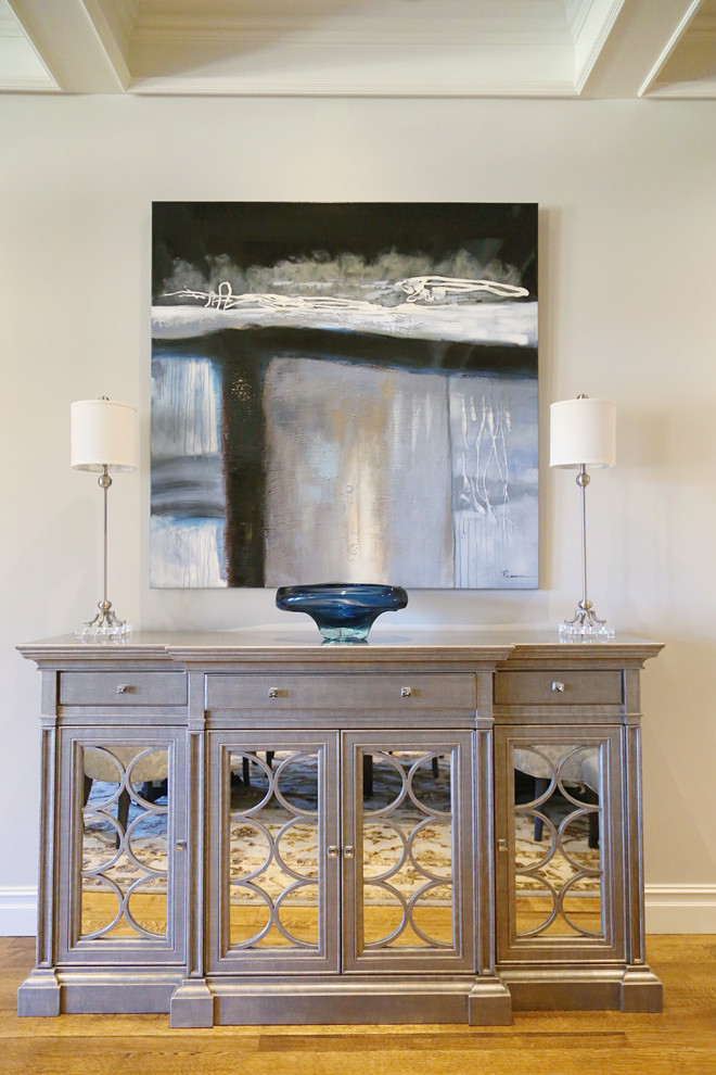 Large transitional medium tone wood floor enclosed dining room photo with gray walls and no fireplace