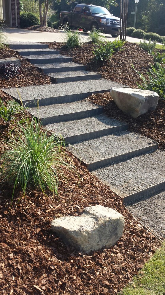 This is an example of a mid-sized modern front yard partial sun driveway in Birmingham with a garden path and gravel.
