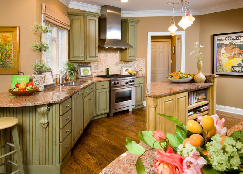 Inspiration for a transitional medium tone wood floor eat-in kitchen remodel in Indianapolis with green cabinets, granite countertops, multicolored backsplash, stainless steel appliances and an island