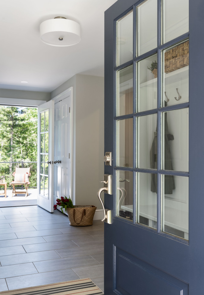 Design ideas for a traditional mudroom in Boston with white walls, ceramic floors, a single front door, a blue front door and grey floor.