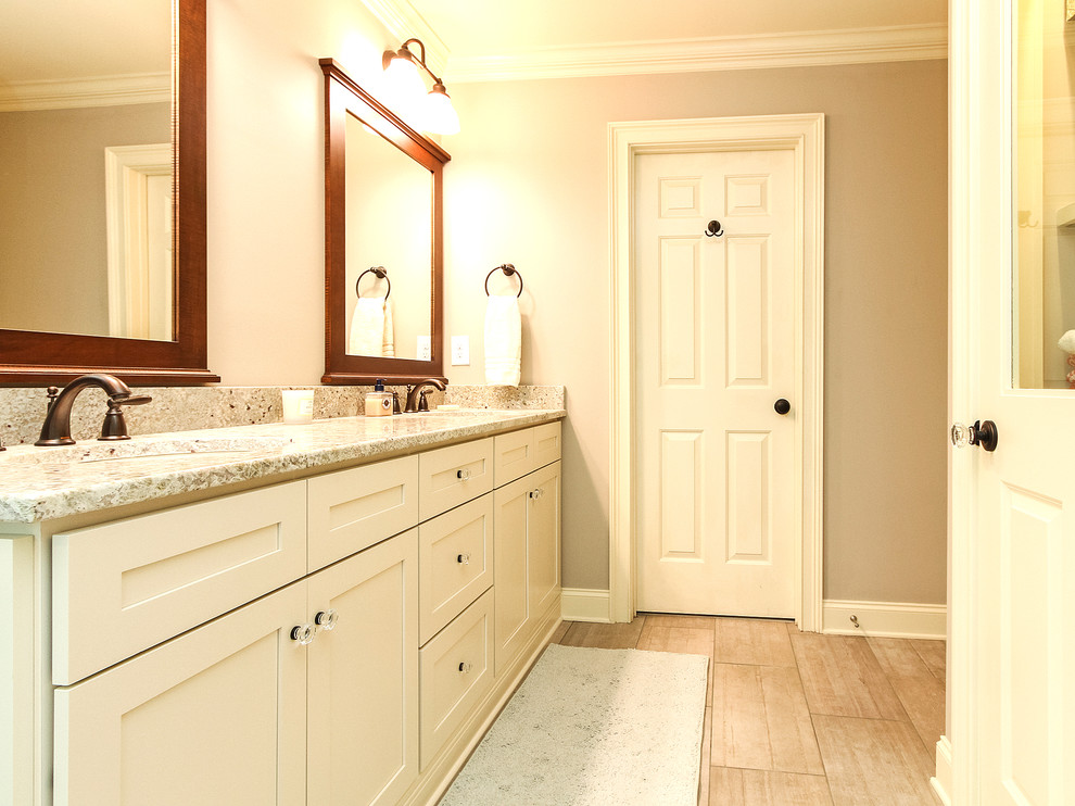Inspiration for a mid-sized arts and crafts master bathroom in Charlotte with an undermount sink, shaker cabinets, yellow cabinets, granite benchtops, a double shower, a two-piece toilet, blue tile, stone tile, grey walls and porcelain floors.