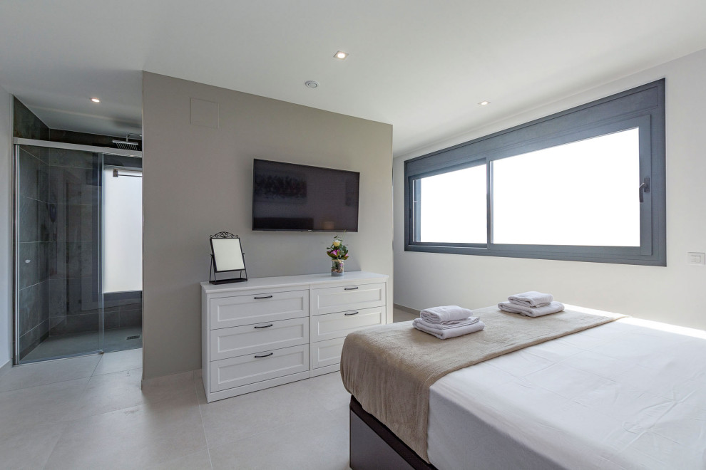 Diseño de dormitorio principal contemporáneo de tamaño medio con paredes beige, suelo de baldosas de cerámica y suelo beige