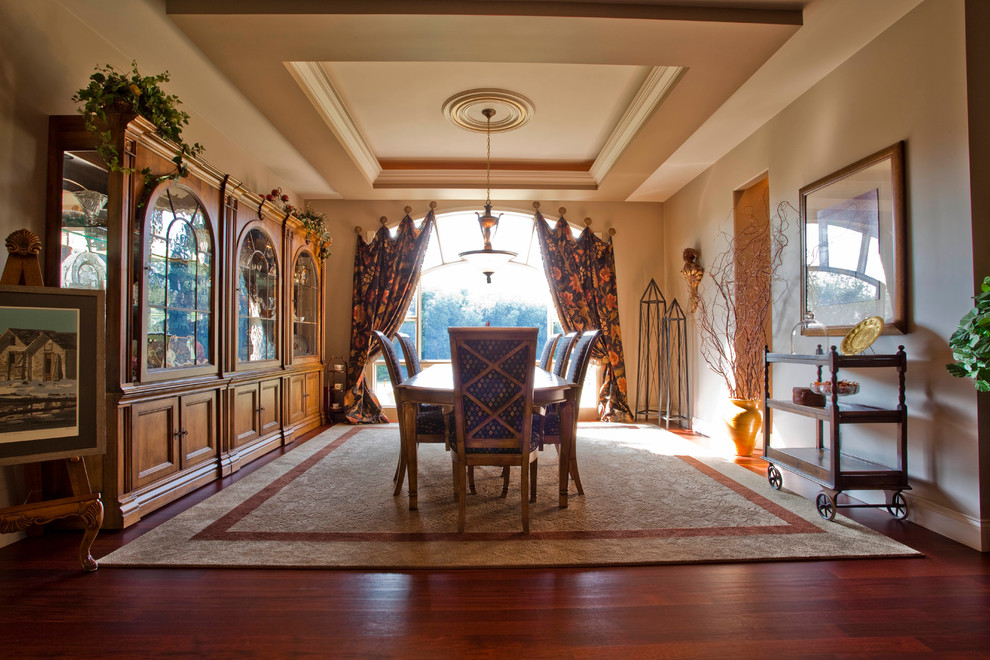 Inspiration for a large traditional separate dining room in Calgary with beige walls and medium hardwood floors.