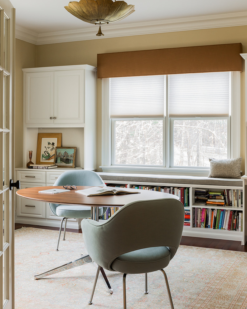 Photo of a transitional study room in Boston with beige walls, dark hardwood floors, no fireplace and a freestanding desk.