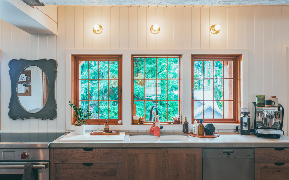 Expansive country l-shaped eat-in kitchen in Vancouver with an undermount sink, shaker cabinets, medium wood cabinets, concrete benchtops, white splashback, shiplap splashback, stainless steel appliances, porcelain floors, with island, beige floor, grey benchtop and timber.