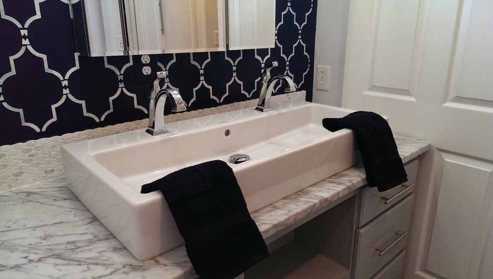 Inspiration for a mid-sized contemporary bathroom in Atlanta with a trough sink, furniture-like cabinets, grey cabinets, marble benchtops, a two-piece toilet, white tile, subway tile, grey walls and dark hardwood floors.