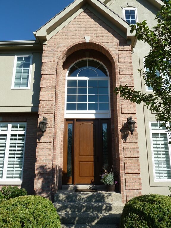 Large transitional front door photo in Chicago with a medium wood front door