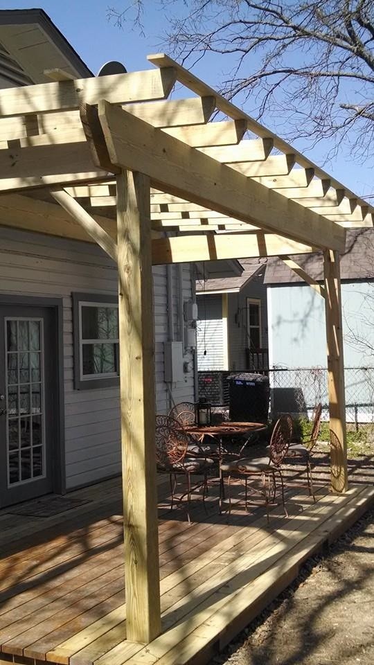Inspiration for a small traditional backyard deck in Austin with a pergola.