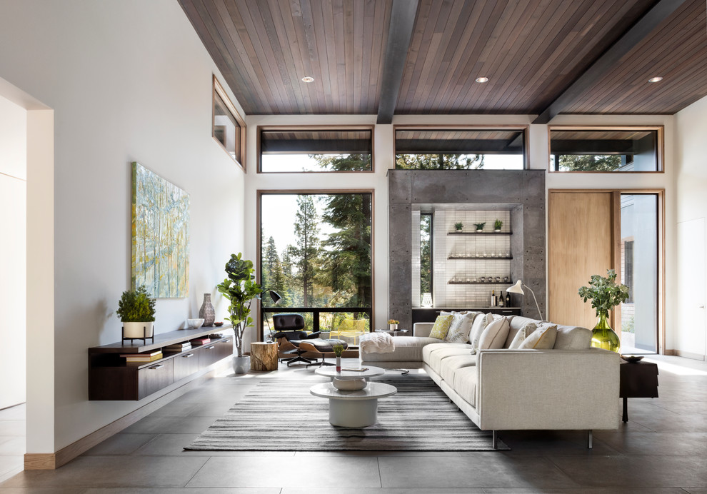 Inspiration for a large modern open concept living room in San Francisco with a home bar, white walls, porcelain floors, a ribbon fireplace and a concrete fireplace surround.
