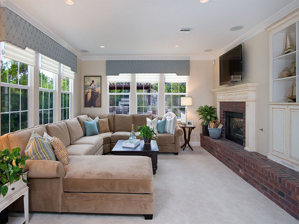 Photo of a traditional family room in San Diego with a brick fireplace surround.