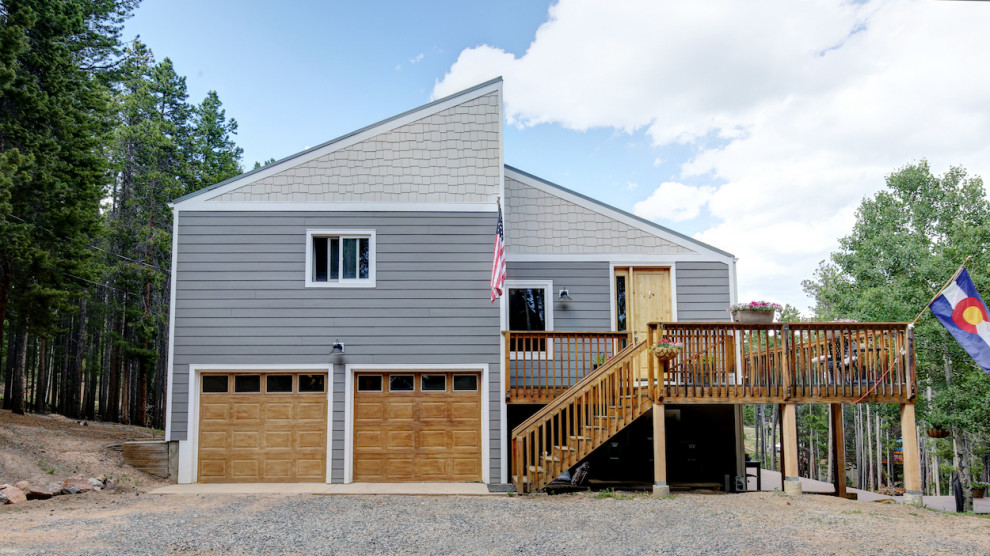 This is an example of a mid-sized country two-storey grey house exterior in Denver with concrete fiberboard siding, a gable roof, a shingle roof, a black roof and shingle siding.