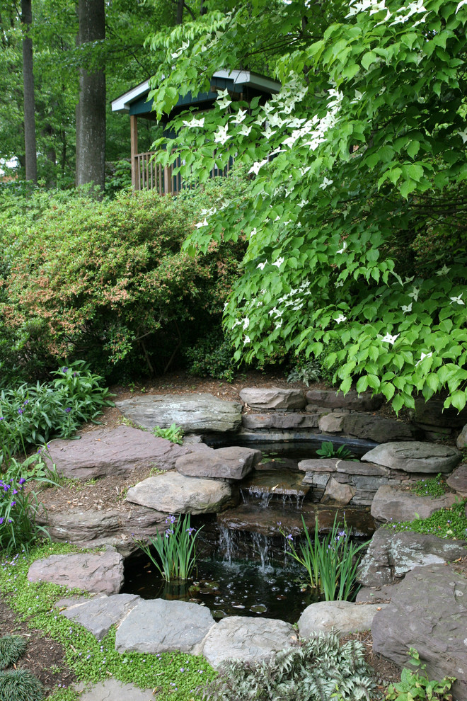 Design ideas for a small modern backyard garden in DC Metro with a water feature and natural stone pavers.