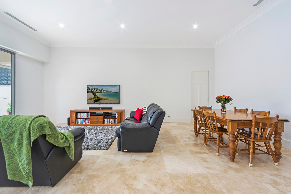 This is an example of a transitional open concept living room in Adelaide with white walls, no fireplace, a wall-mounted tv and beige floor.