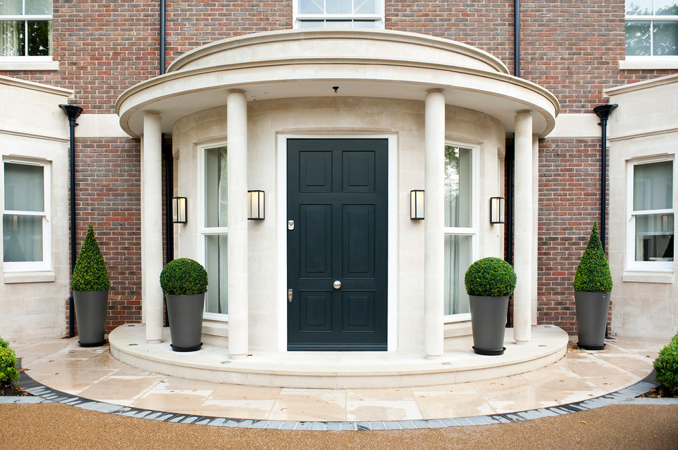 Inspiration for an expansive transitional front door in Gloucestershire with a black front door.