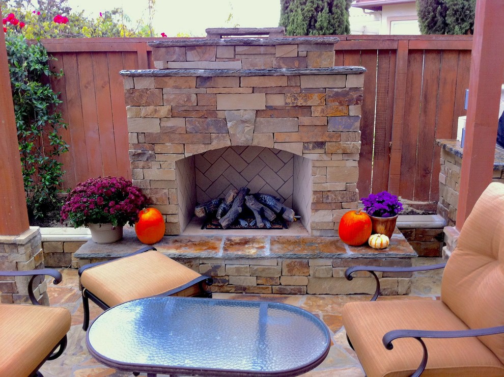 Photo of a mid-sized traditional backyard patio in San Diego with a fire feature, a pergola and natural stone pavers.