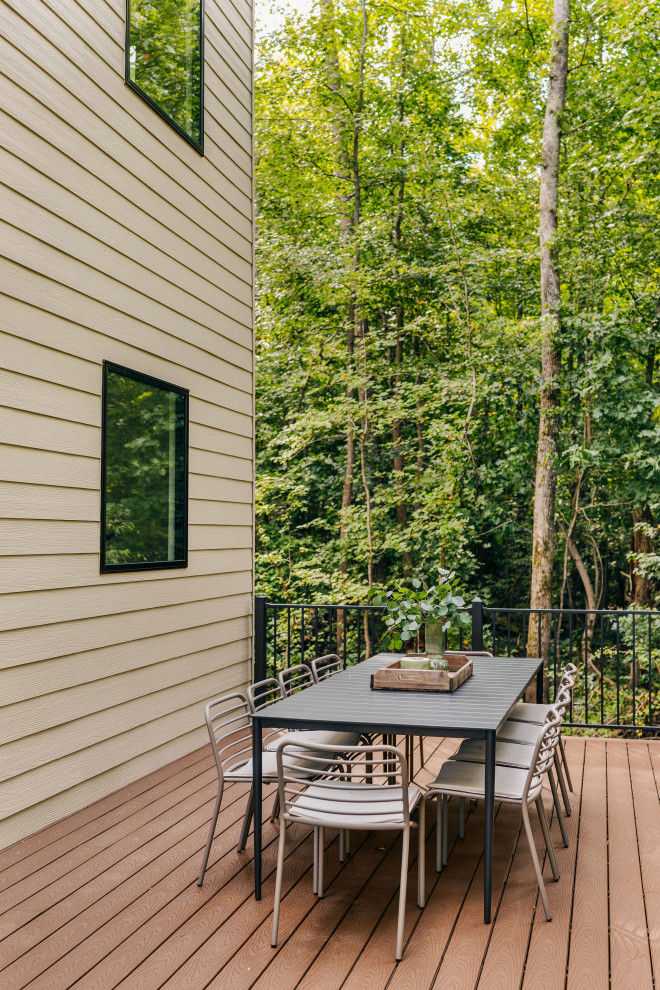 Deck - large backyard ground level metal railing deck idea with no cover