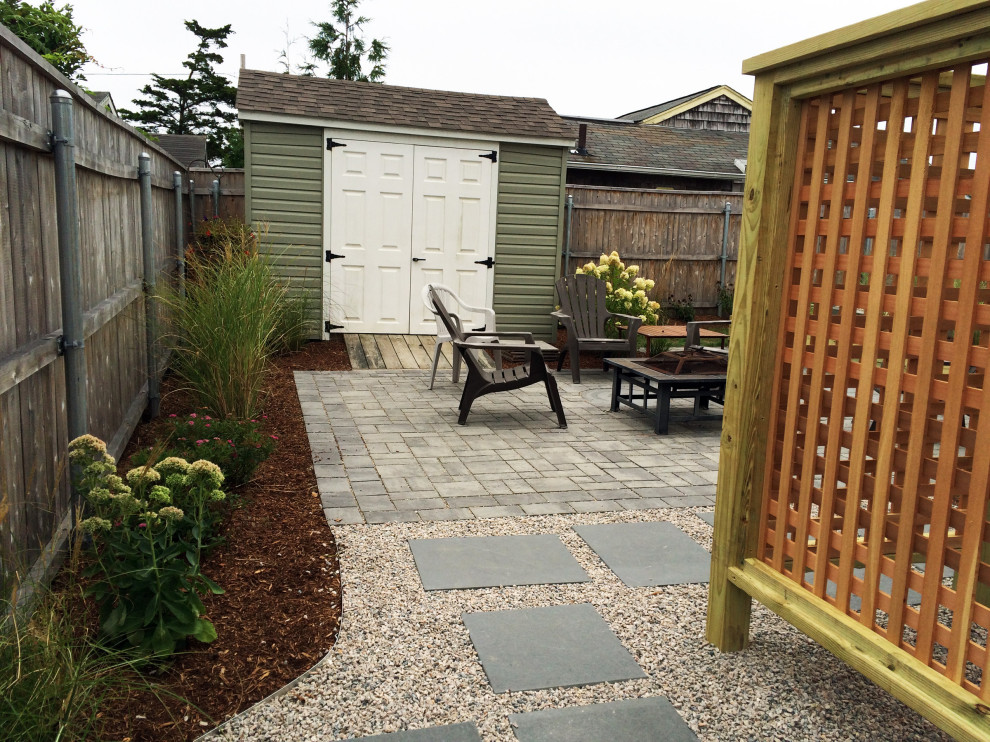 Design ideas for a small beach style backyard patio in Providence with an outdoor shower and concrete pavers.