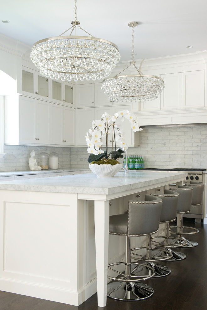 Design ideas for a transitional kitchen in New York with shaker cabinets, white cabinets, grey splashback, subway tile splashback, stainless steel appliances, dark hardwood floors and with island.