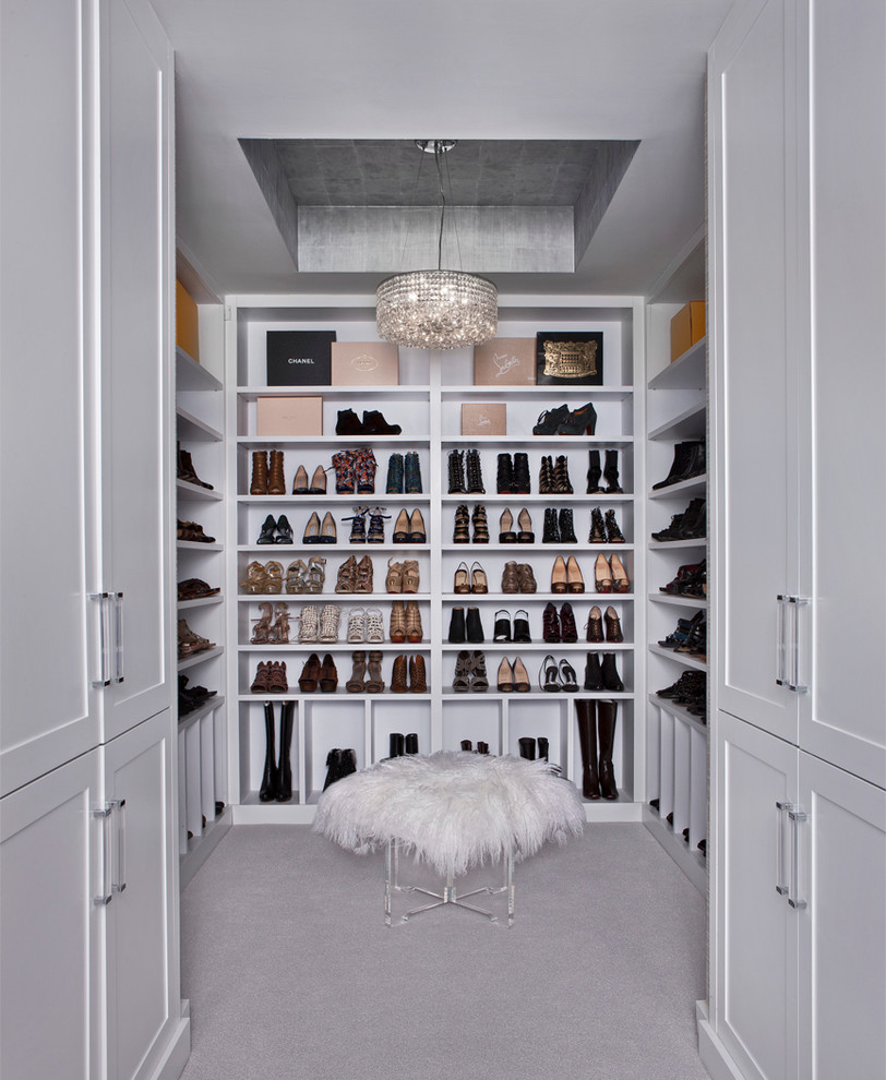 Photo of a transitional women's dressing room in Detroit with open cabinets, white cabinets and carpet.