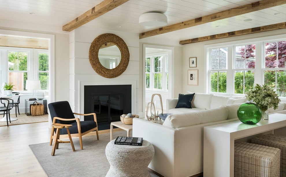 Inspiration for a large beach style open concept family room in Providence with beige walls, light hardwood floors, a standard fireplace, beige floor and no tv.