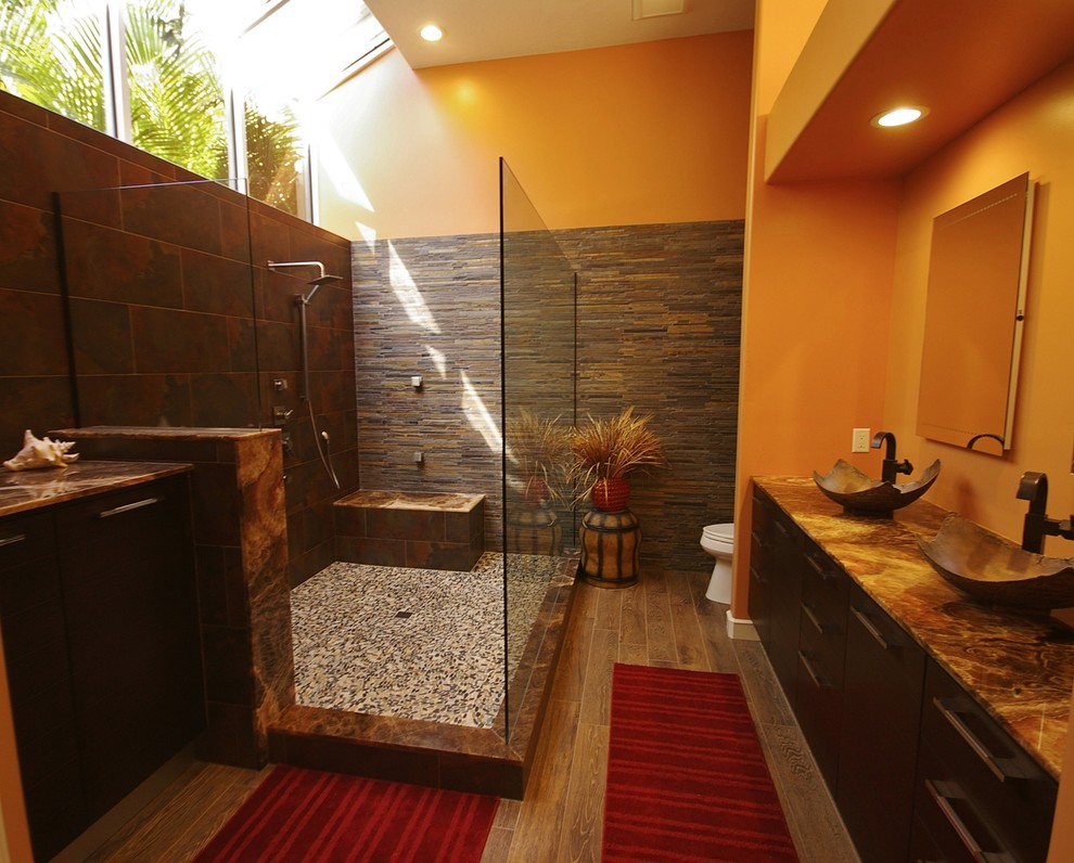 Eclectic master bathroom in Tampa with a vessel sink, an open shower, flat-panel cabinets, dark wood cabinets, onyx benchtops, multi-coloured tile and porcelain tile.