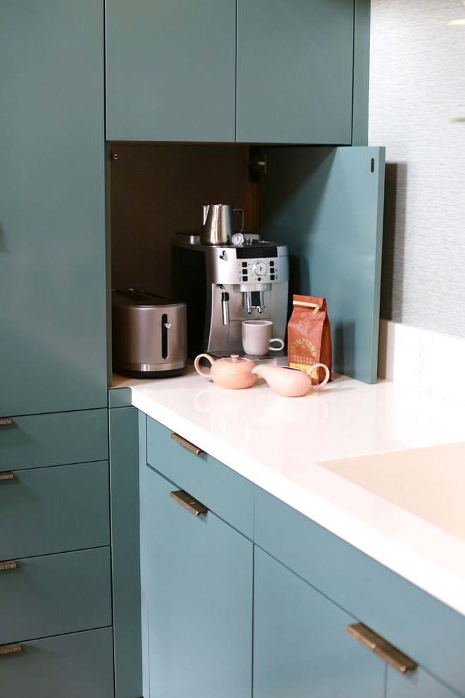 Photo of a mid-sized transitional galley eat-in kitchen in San Francisco with an integrated sink, flat-panel cabinets, green cabinets, granite benchtops, green splashback, concrete floors, with island and green floor.