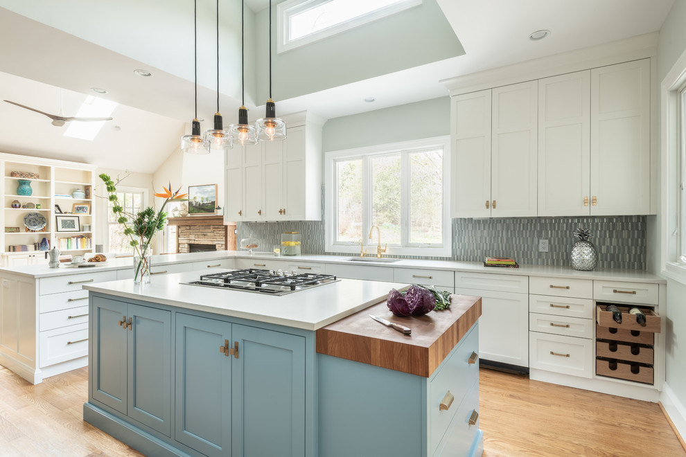 Inspiration for a large transitional l-shaped open plan kitchen in DC Metro with shaker cabinets, blue cabinets, wood benchtops, blue splashback, ceramic splashback, panelled appliances and with island.