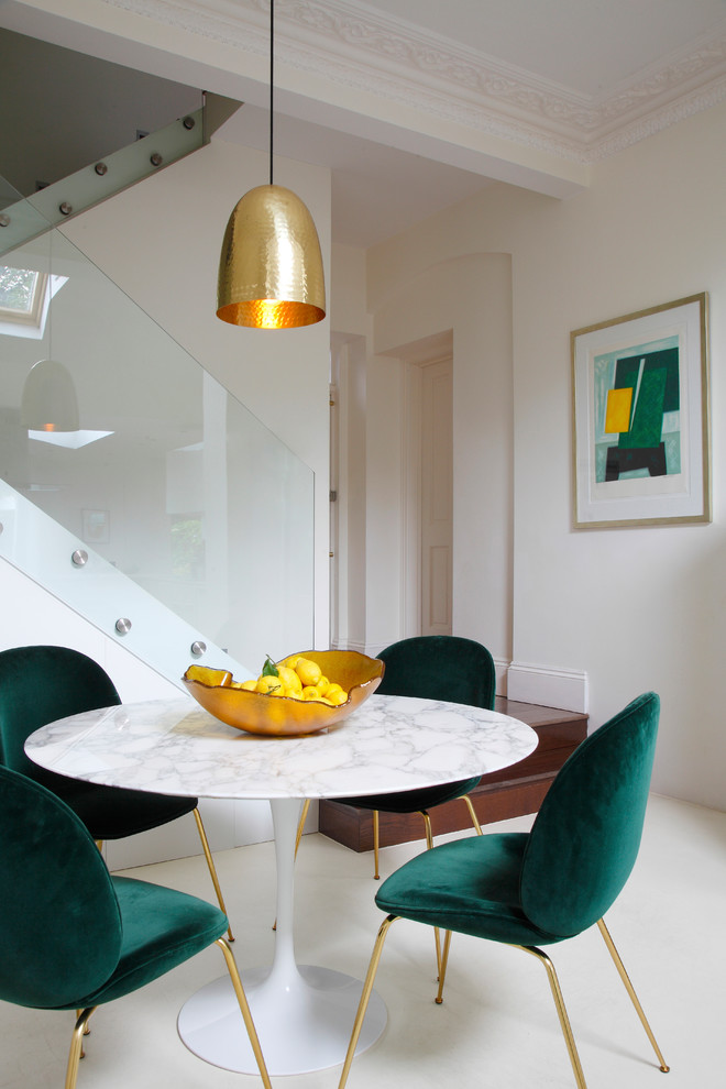 This is an example of a dining room in London with beige walls and beige floor.