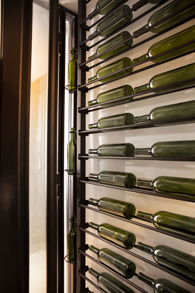 Inspiration for a small midcentury wine cellar in Orlando with storage racks.