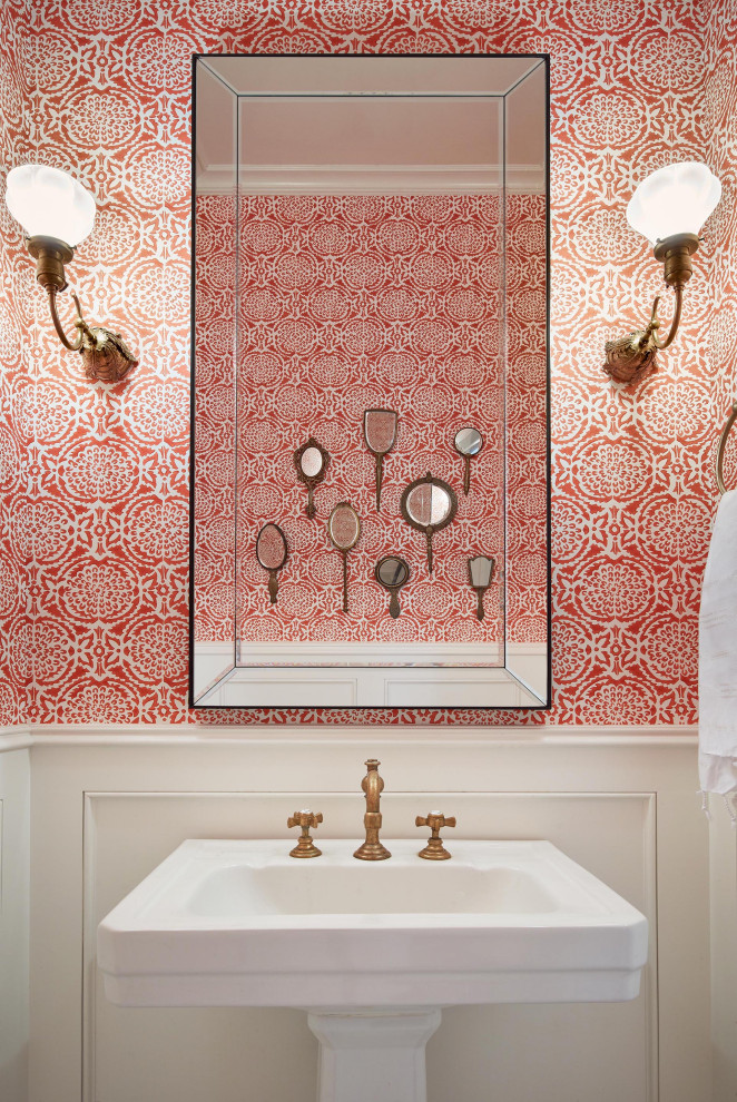 This is an example of a small traditional powder room in San Francisco with red walls, a pedestal sink, decorative wall panelling and wallpaper.