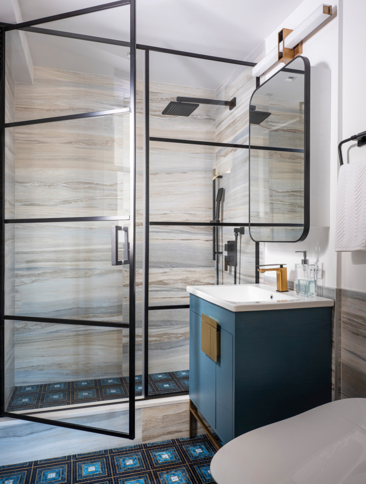 Photo of a transitional master bathroom in New York with flat-panel cabinets, blue cabinets, an alcove shower, an integrated sink, engineered quartz benchtops, multi-coloured floor, a hinged shower door, white benchtops, a single vanity and a built-in vanity.