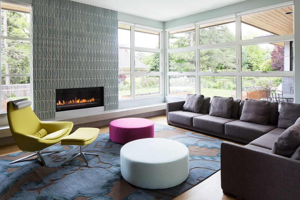 Photo of a contemporary living room in New York with light hardwood floors and a ribbon fireplace.