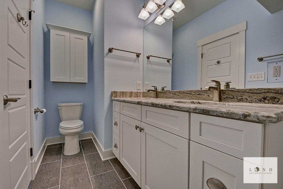Design ideas for a mid-sized arts and crafts bathroom in Indianapolis with shaker cabinets, white cabinets, white walls, granite benchtops, a shower seat, a double vanity and a built-in vanity.