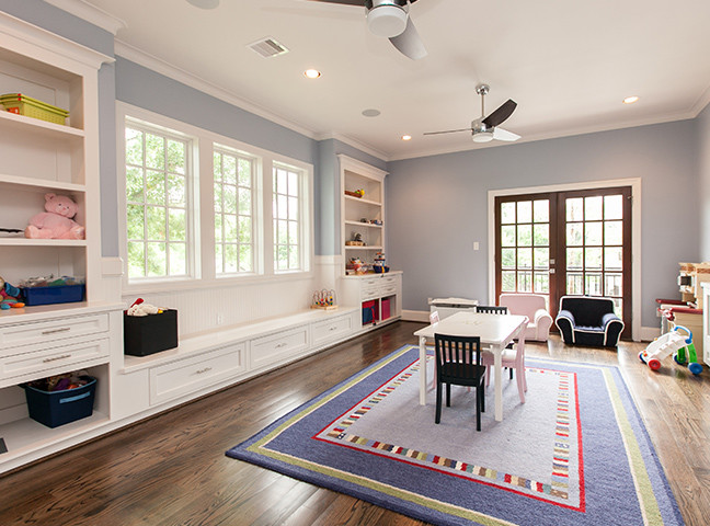 Design ideas for a mid-sized traditional gender-neutral kids' playroom for kids 4-10 years old in Houston with blue walls and medium hardwood floors.