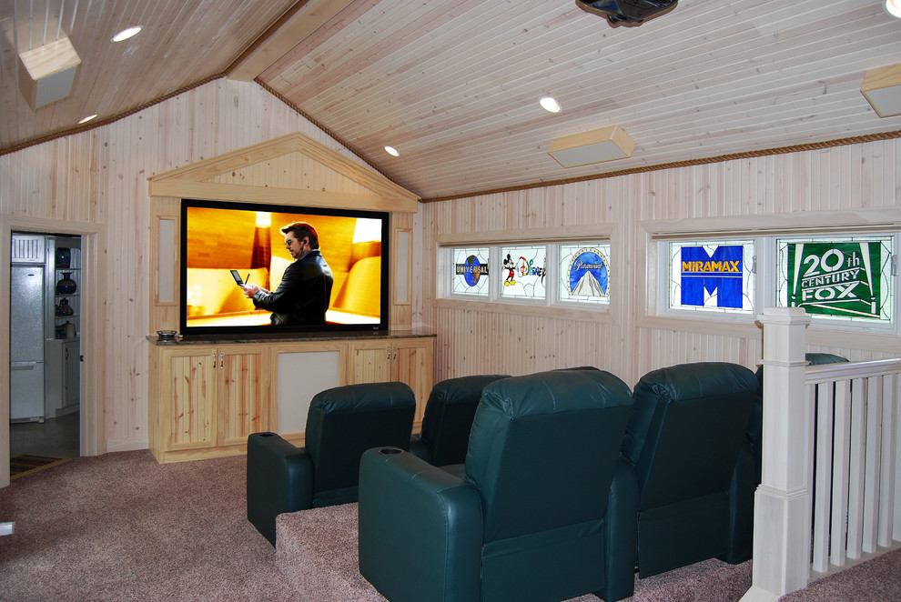 Photo of a small eclectic enclosed home theatre in Cleveland with carpet and a projector screen.