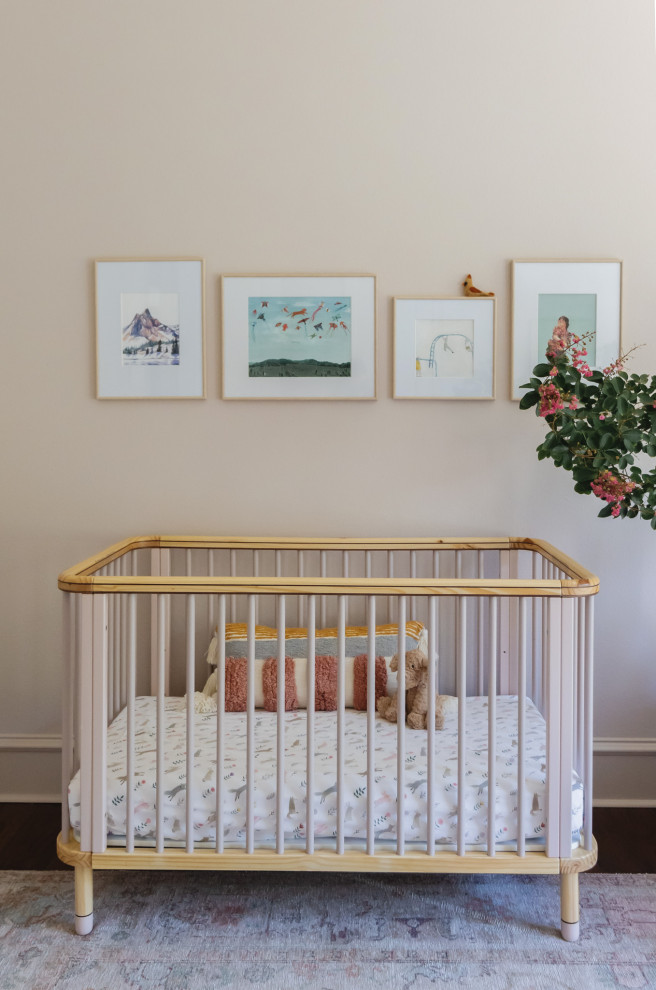 Inspiration for a mid-sized modern girl dark wood floor and brown floor nursery remodel in Dallas with pink walls