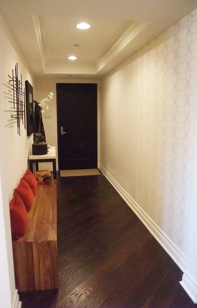 Inspiration for a small contemporary foyer in Los Angeles with white walls and dark hardwood floors.